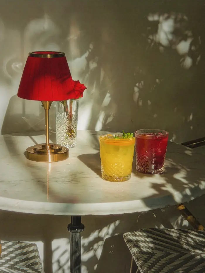 Two drinks under a red lamp